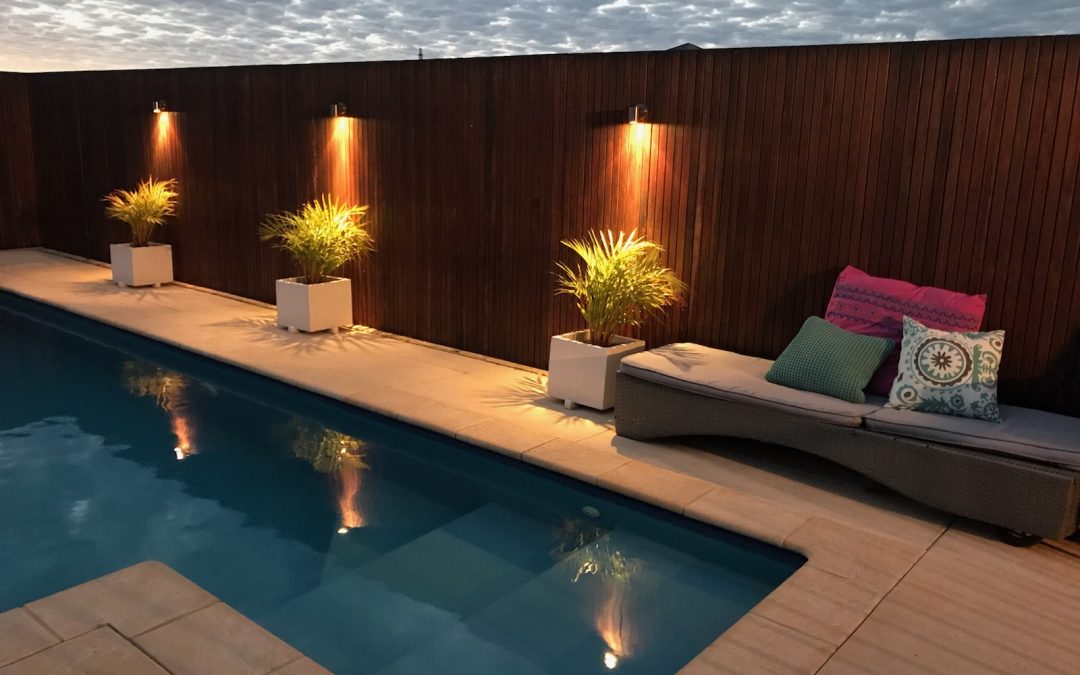 swimming pool installation with beautiful poolside lighting