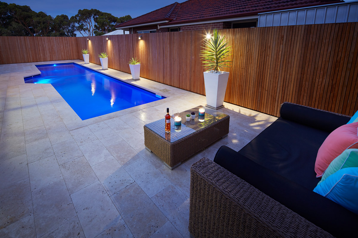 fibreglass pool with complete landscape package in a backyard