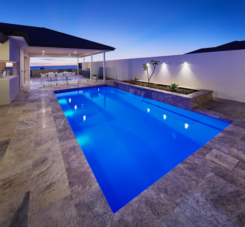 Professional fibreglass pool installation with underwater lights and landscaping